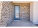 Stylish stone facade frames a modern blue front door with glass panel and house number 47 at 2121 W Sonoran Desert Dr # 47, Phoenix, AZ 85085