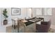 Modern home office setup with stylish desk, comfortable chairs, ample lighting, and contemporary artwork at 2121 W Sonoran Desert Dr # 47, Phoenix, AZ 85085