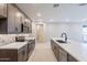 Well-lit kitchen featuring stainless steel appliances, dark wood cabinets, and stylish backsplash at 2121 W Sonoran Desert Dr # 47, Phoenix, AZ 85085