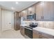 Modern kitchen featuring stainless steel appliances, plenty of counter space, and wooden cabinets at 2121 W Sonoran Desert Dr # 47, Phoenix, AZ 85085