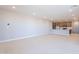 Open-concept living area with tiled floors seamlessly connecting to a modern kitchen at 2121 W Sonoran Desert Dr # 47, Phoenix, AZ 85085