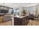 Modern kitchen island featuring granite countertops and seating, with a view into the living area at 21236 N 58Th St, Phoenix, AZ 85054