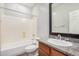 Bathroom with granite countertop, framed mirror, and tub with shower at 2242 W Calle Marita --, Phoenix, AZ 85085