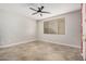 This bedroom features a modern ceiling fan, window with blinds, and neutral paint at 2242 W Calle Marita --, Phoenix, AZ 85085