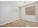 This bedroom features a ceiling fan, window with blinds, and neutral paint at 2242 W Calle Marita --, Phoenix, AZ 85085