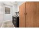 Well-lit laundry room with washer, dryer, and wooden cabinet at 2242 W Calle Marita --, Phoenix, AZ 85085