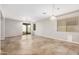 Spacious living room featuring sliding doors, a ceiling fan with a light fixture, and neutral walls at 2242 W Calle Marita --, Phoenix, AZ 85085