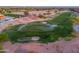 Scenic aerial view of the golf course with sprinklers on the green and sand traps at the community at 2369 E Fiesta Dr, Casa Grande, AZ 85194