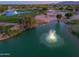 Scenic view of a pond with a fountain on a golf course in the residential community at 2369 E Fiesta Dr, Casa Grande, AZ 85194
