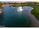 Scenic view of a pond with a fountain on a golf course in the residential community at 2369 E Fiesta Dr, Casa Grande, AZ 85194