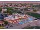 Community clubhouse and pool area with lounge chairs and umbrellas, surrounded by palm trees at 2369 E Fiesta Dr, Casa Grande, AZ 85194