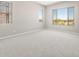 Bright bedroom featuring neutral tones, ample natural light, and views of the surrounding landscape at 26650 W Siesta Ln, Buckeye, AZ 85396