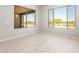 Bright bedroom featuring large windows with scenic views and tile flooring at 26650 W Siesta Ln, Buckeye, AZ 85396