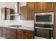 Modern kitchen featuring stainless steel appliances, granite countertops, and custom cabinetry at 26650 W Siesta Ln, Buckeye, AZ 85396