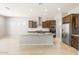 Bright kitchen with stainless steel appliances, a large island, and ample cabinet space at 26650 W Siesta Ln, Buckeye, AZ 85396