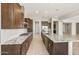 Elegant kitchen with a large island, granite countertops, and stainless steel appliances at 26650 W Siesta Ln, Buckeye, AZ 85396