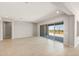 Open living room featuring tile floors, recessed lighting, and large sliding glass doors at 26650 W Siesta Ln, Buckeye, AZ 85396