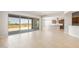 Spacious living room has tile floors, large windows with views, and flows into the modern kitchen at 26650 W Siesta Ln, Buckeye, AZ 85396