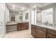 Elegant bathroom featuring granite countertops, double sinks, and large mirrors at 26650 W Siesta Ln, Buckeye, AZ 85396