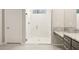 Modern shower with white subway tile, glass door, and rainfall shower head at 26650 W Siesta Ln, Buckeye, AZ 85396