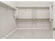 Spacious walk-in closet featuring ample shelving and carpeting at 26650 W Siesta Ln, Buckeye, AZ 85396