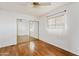 This bedroom features hardwood floors, a ceiling fan and a large mirrored closet at 2700 E Allred Ave # B20, Mesa, AZ 85204