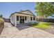 Back of home with covered patio with large pavers and small section of grass at 2778 E Devon Ct, Gilbert, AZ 85296