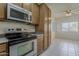 Close up of kitchen with stainless steel oven and wood cabinets at 2778 E Devon Ct, Gilbert, AZ 85296