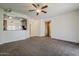 Open-concept living room with carpet flooring, a ceiling fan, and views of the kitchen at 2778 E Devon Ct, Gilbert, AZ 85296