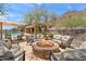 Outdoor firepit surrounded by comfortable seating, located next to the community pool at 36600 N Cave Creek Rd # 9B, Cave Creek, AZ 85331