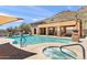 A pristine community pool and hot tub are surrounded by luxurious lounging, set against desert mountain views at 36600 N Cave Creek Rd # 9B, Cave Creek, AZ 85331