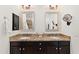 Well-lit bathroom featuring double sinks, granite countertops and decorative mirrors at 36600 N Cave Creek Rd # 9B, Cave Creek, AZ 85331