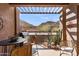 Inviting patio area with mountain views, a grill, and comfortable seating under a pergola at 36600 N Cave Creek Rd # 9B, Cave Creek, AZ 85331