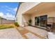 Comfortable backyard patio with decorative gravel accents, and sliding glass door entry into the home at 36728 N Alderney Ct, San Tan Valley, AZ 85143