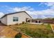 Spacious backyard with built-in grill, lush green lawn, and drought-resistant landscaping, creating a serene outdoor space at 36728 N Alderney Ct, San Tan Valley, AZ 85143