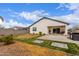 Beautiful backyard with a lush lawn, outdoor kitchen, and inviting patio, great for relaxing and entertaining guests at 36728 N Alderney Ct, San Tan Valley, AZ 85143