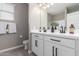 Bright bathroom with double sinks, a quartz countertop, and matte black hardware at 36728 N Alderney Ct, San Tan Valley, AZ 85143