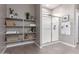 This bathroom features storage shelves and a glass shower at 36728 N Alderney Ct, San Tan Valley, AZ 85143