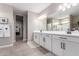 This primary bathroom features double sinks and a large mirror at 36728 N Alderney Ct, San Tan Valley, AZ 85143