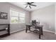 Bedroom with a ceiling fan, a large window and a wooden desk at 36728 N Alderney Ct, San Tan Valley, AZ 85143