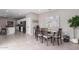 Cozy dining area features a wooden table with seating for six, and views of the modern kitchen at 36728 N Alderney Ct, San Tan Valley, AZ 85143