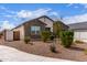 Single-story home with stone accents, a well-maintained front yard, and a gated side entrance at 36728 N Alderney Ct, San Tan Valley, AZ 85143