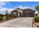 Beautiful home features a well-maintained front yard, gray color scheme, and attached two-car garage at 36728 N Alderney Ct, San Tan Valley, AZ 85143