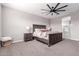 This primary bedroom features a ceiling fan, a bed, and two nightstands at 36728 N Alderney Ct, San Tan Valley, AZ 85143