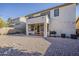 Spacious backyard with gravel, patio, dining set, and string lights perfect for outdoor entertaining at 3816 E Phelps St, Gilbert, AZ 85295