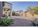 Charming backyard featuring a covered patio, gravel ground cover, and block wall providing privacy at 3816 E Phelps St, Gilbert, AZ 85295