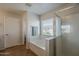 Bright bathroom featuring a soaking tub with shower and tile flooring at 3816 E Phelps St, Gilbert, AZ 85295