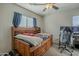 Bedroom features a ceiling fan, natural light, and a wooden bed frame at 3816 E Phelps St, Gilbert, AZ 85295