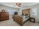 Bedroom featuring neutral walls, a ceiling fan, and an impressive wood-frame bed set at 3816 E Phelps St, Gilbert, AZ 85295