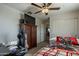 Bedroom features a ceiling fan, dresser with TV, and a sliding door closet at 3816 E Phelps St, Gilbert, AZ 85295